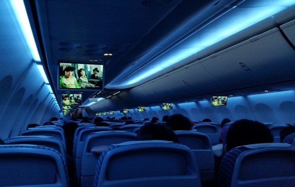 passengers watching a movie on an overnight flight