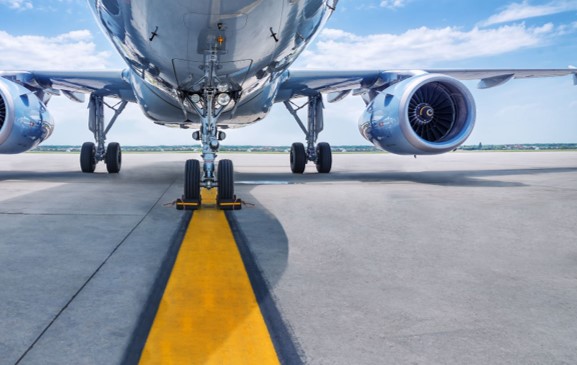 underside of an airplane on the tarmac